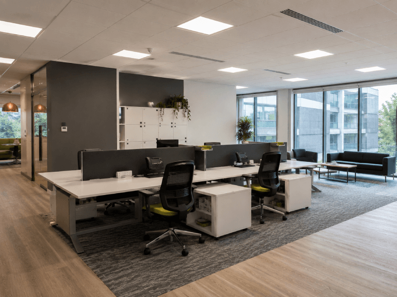 Modern office floor and ceiling renovations featuring suspended ceilings, premium flooring, and contemporary commercial interiors.